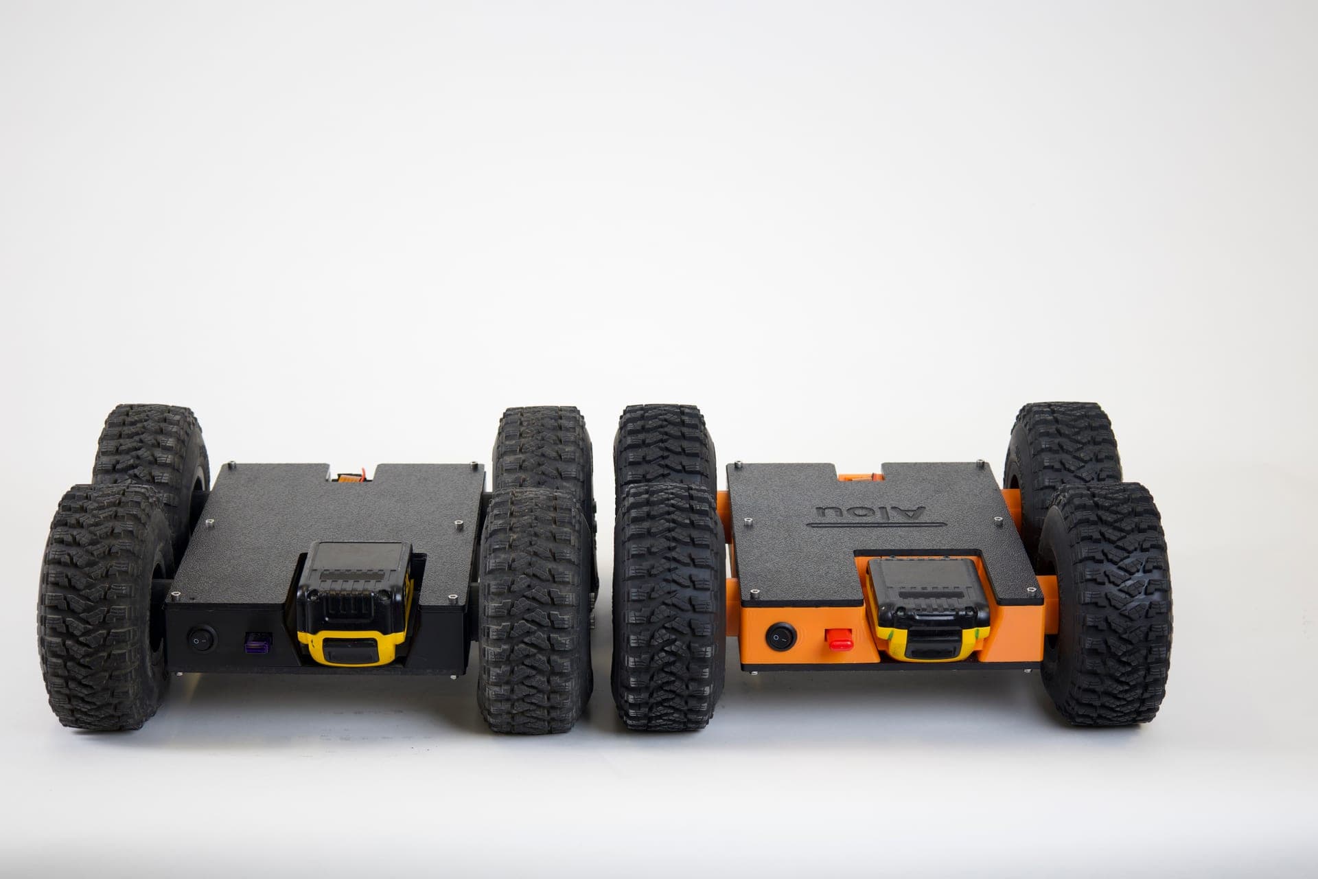 Black and orange Scrutinizer robots showing battery placement
