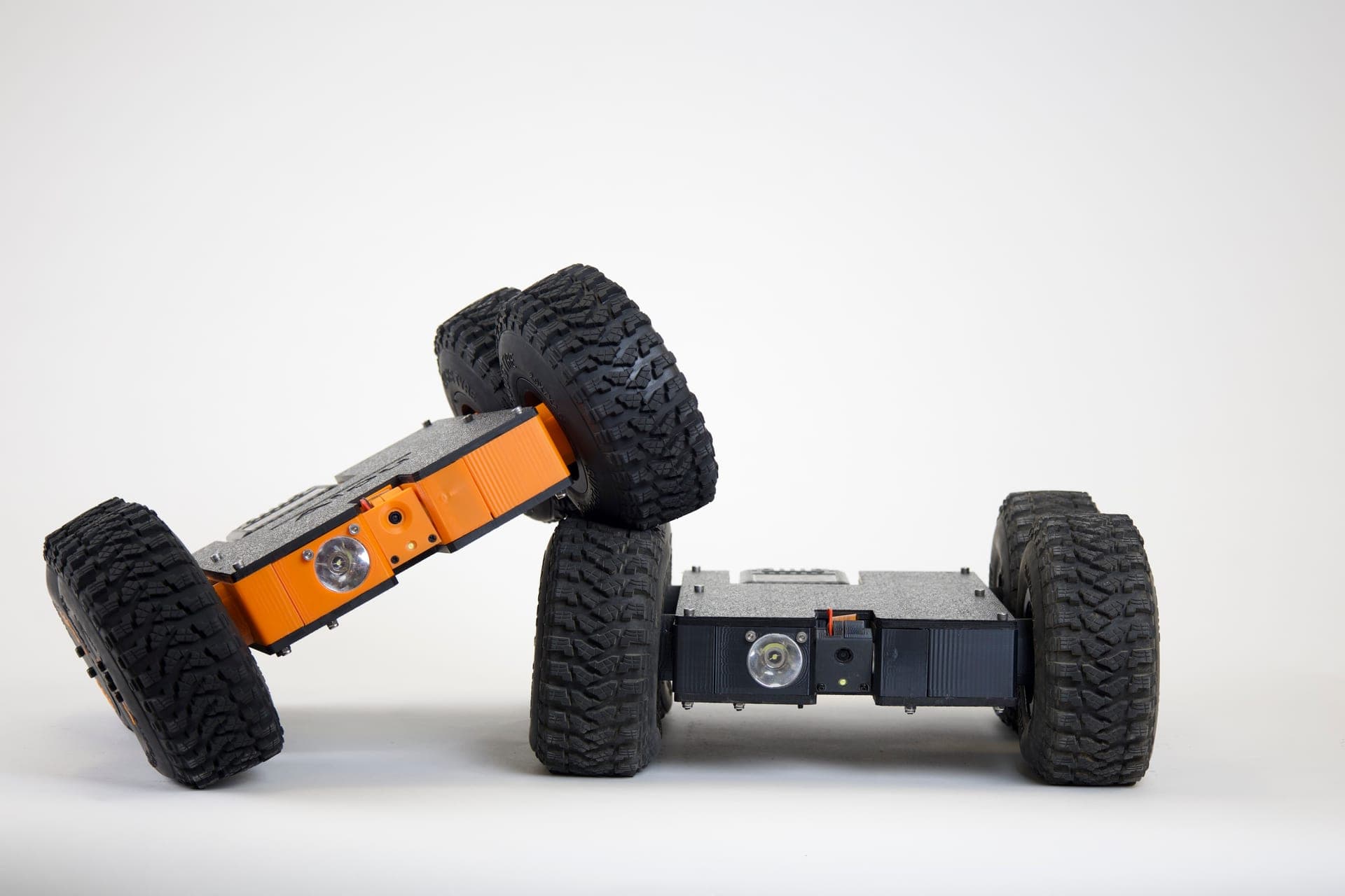 Orange and black Scrutinizer crawlspace robots showing low-profile tire stance